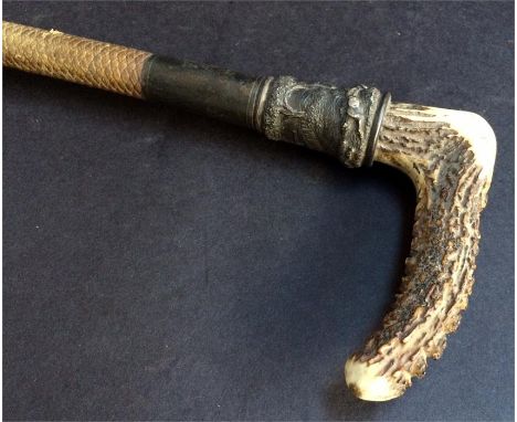 A 19th century hunting whip retailed by Swaine & Co, London, with antler handle and whalebone shaft, the white metal collar i