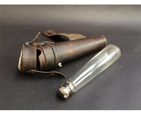 A conical glass hunting flask with silver tops (marks rubbed), contained in a leather holder for saddle mounting