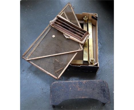 A brass fire screen, brass fire dogs, and cast iron trivet