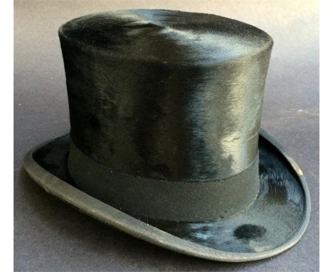 A leather top hat box with fitted interior containing black silk hunting top hat made by Tress & Co, London with cord and a s