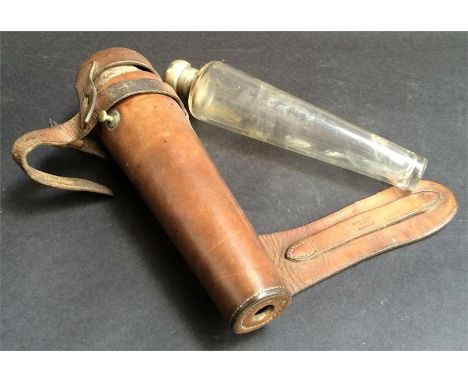 A conical glass hunting flask with silver plate top, made in England, contained in a leather holder for saddle mounting, impr