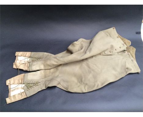 Two pairs of cavalry twill hunting breeches, one green pair (possibly military) laced to the knee, the second pair buff with 