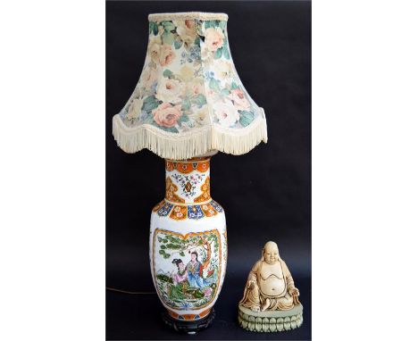 A resin Buddha and an oriental lamp with shade