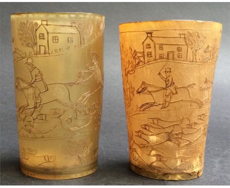 A pair of early 19th century carved horn beakers, each 10cm high, depicting hunting scenes to include riders in landscape, ho