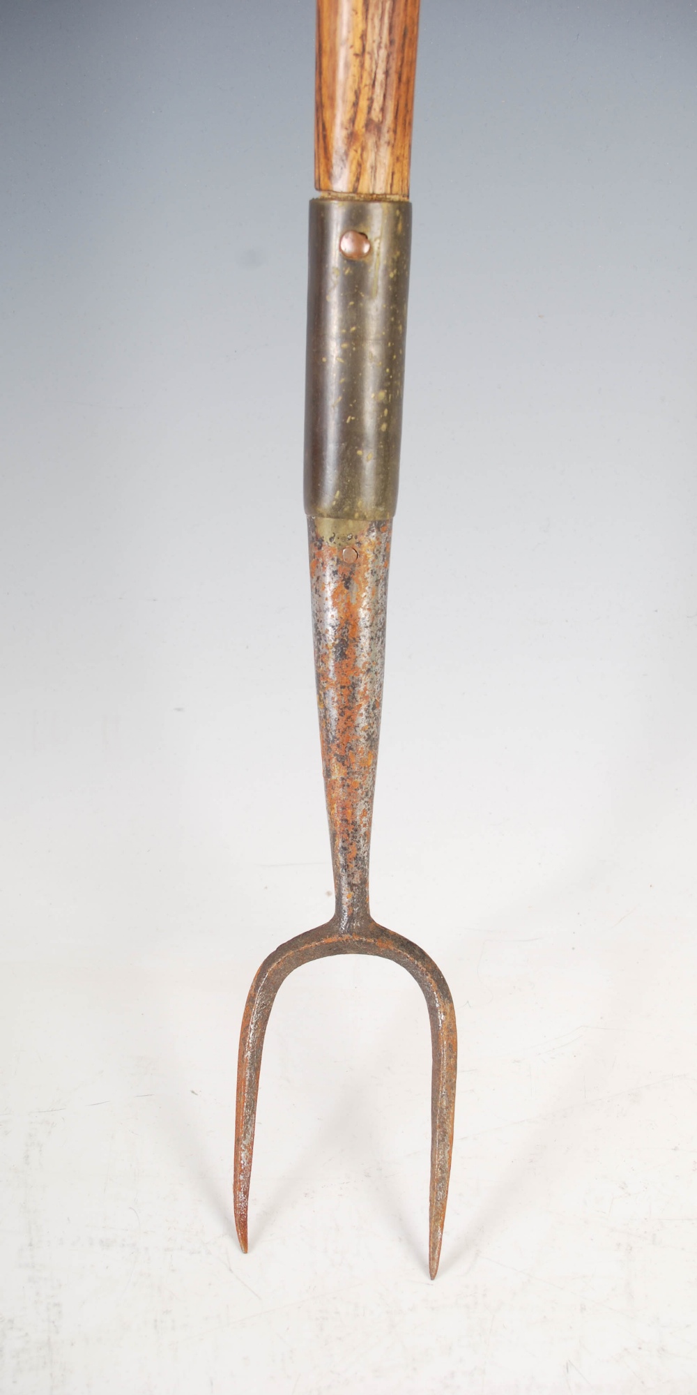 An antique pitch fork, with steel prongs and turned ash handle, 93cm long.