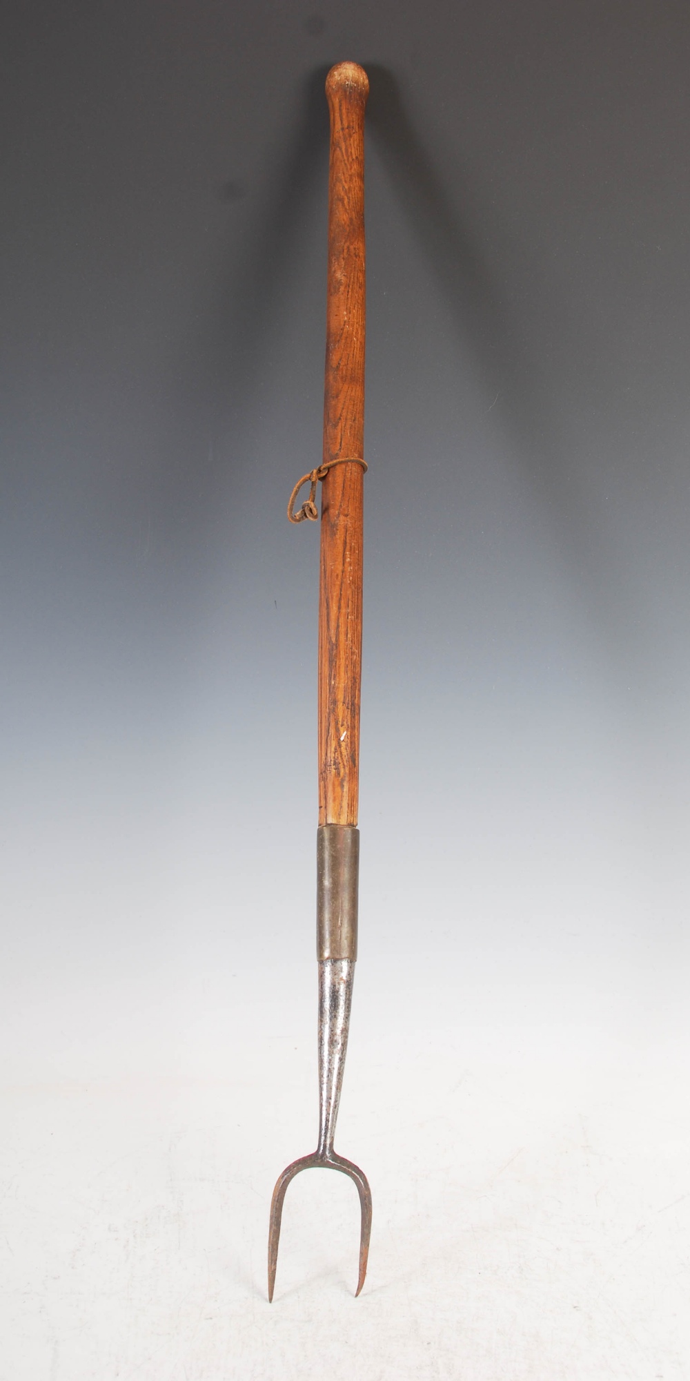 An antique pitch fork, with steel prongs and turned ash handle, 93cm long.