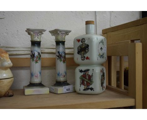 PAIR OF CERAMIC CANDLESTICKS TOGETHER WITH A NOVELTY SPIRIT BOTTLE (3)