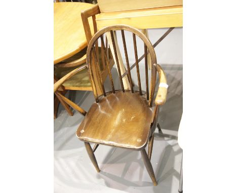 A vintage Ercol dark elm elbow chair. This lot is not available for in-house P&amp;P. 