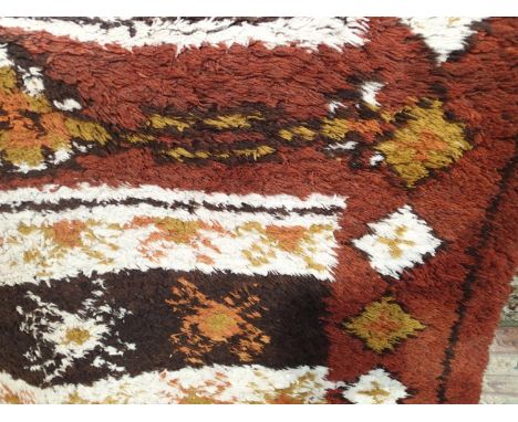 Large shag pile brown ground carpet in good condition. Approx 250 x 350 cm. This item is not available for in-house P&amp;P.