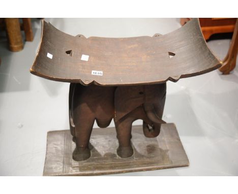 Ethnic hand carver ebony curved seat stool with elephant support base W: 90 cm. This lot is not available for in-house P&amp;