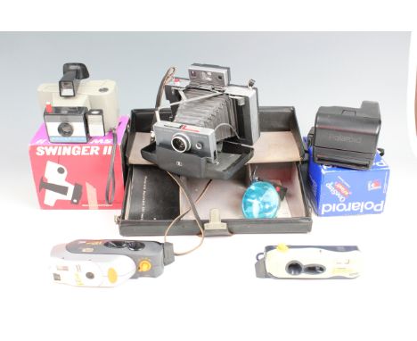 A cased Polaroid Automatic 100 Land Camera with flash and instructions together with five other Polaroid cameras