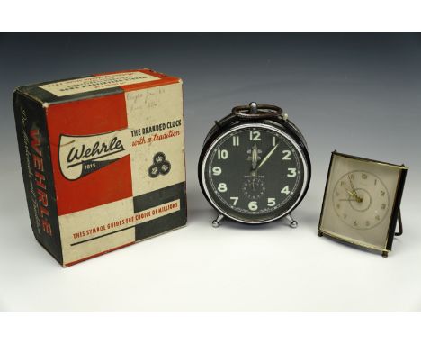 A vintage Wehrle "Three-in-One" bedside alarm clock, in original carton, circa 1950s, together with a 1950s Kienzle alarm clo
