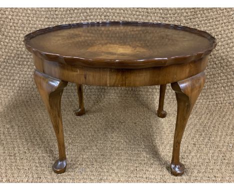 A Georgian style walnut coffee table, having Chippendale pie-crust top and cabriole legs, ex-Champan's, third quarter 20th Ce