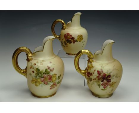 Three graduated Royal Worcester blush ivory jugs, with enamelled floral decoration, shape 1094, 13.5 cm, 13 cm, 10.5 cm.
