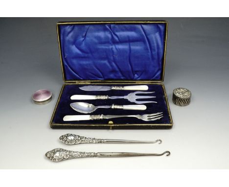 A cased silver and mother of pearl table set, consisting of butter knife, jam spoon, and two pickle forks in a fitted case 22