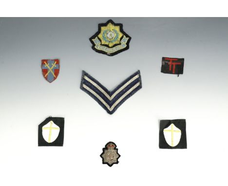 A small group of military and other cloth insignia including a pair of slip-on 8th Army shoulder flashes and a National Fire 