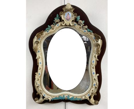 A Victorian flamboyant carved and painted wooden dressing table mirror, the frame embellished with shells, swags and angels' 