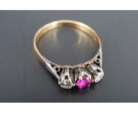 A vintage three-stone ruby and diamond ring, comprising a central ruby of approx 3 mm diameter flanked by diamonds, platinum 