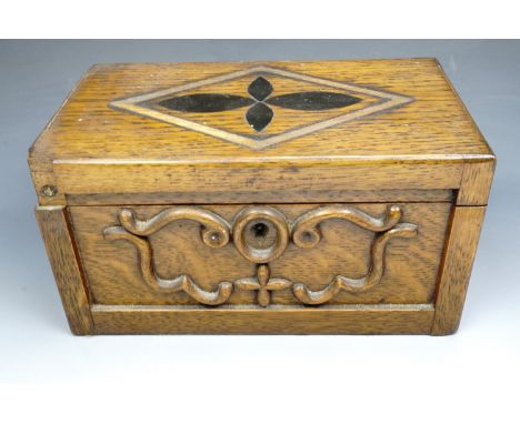 A late Victorian two compartment oak tea caddy