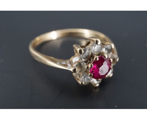 A 1960s ruby and white stone cluster ring, the ruby of approx 4 mm, set on 9 ct gold, P/Q, 1.9 g