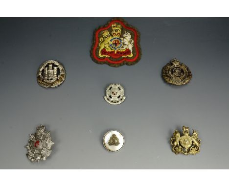 A small group of British army insignia including a Border Regiment cap badge of circa 1953-9