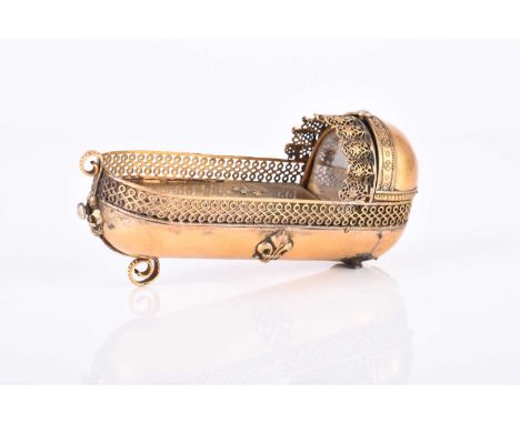 A French gilt brass novelty snuff box, circa 1838Modelled as the crib of King Louis XIV and inscribed 'Jei Naquit Louis XIV, 