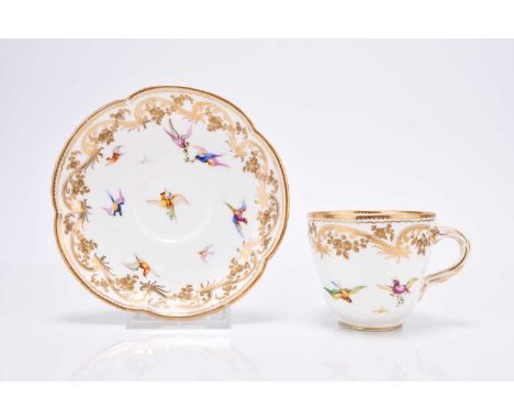 A Coalport coffee cup and saucer, circa 1860, painted by John Randall in his earlier style with small exotic birds below a ra