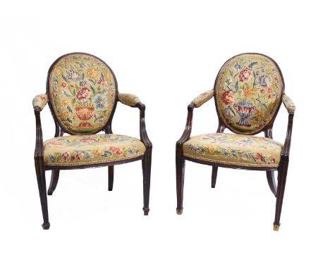 A pair of Regency mahogany upholstered open armchairsThe oval backs and padded arms over padded seats, with floral tapestry c