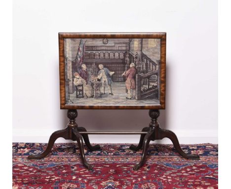 A carved mahogany occasional table with tapestry inset tilt-topRaised on twin fluted tripod supports united by a plain stretc