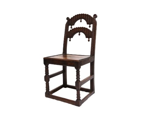 A 17th century oak backstool, probably South YorkshireCirca 1640-50, the back with crescent shaped splats having pendant fini