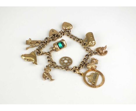 A 9ct gold charm bracelet with attached 9ct gold and yellow metal charms, including; a woodpecker on a trunk, a lion, a lidde