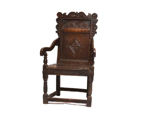 * A 17th century oak 'wainscot' armchair, Leeds area, YorkshireThe scroll carved top rail above a lunette frieze and a lozeng