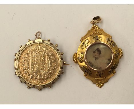 A 19th Century yellow metal pendant, enamel detail, glazed panels for photographs, 11.9 grams approx; a silver gilt 1887 coin