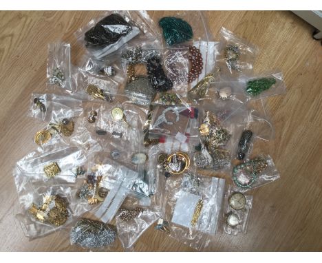 A large collection of costume jewellery to include paste set brooches, faux pearl beads, gilt and white metal, clip on earrin