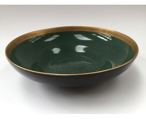  A Royal Worcester bowl; ogee shaped with shell ans scroll guilt rim against a sage green ground. Ref 2577  to the base. 30.5