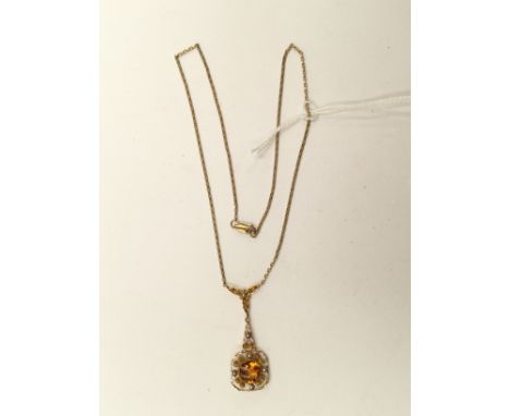 An 18k marked continental pendant, set to the centre with  a buff top citrine, seed pearl and gold scroll details approx leng