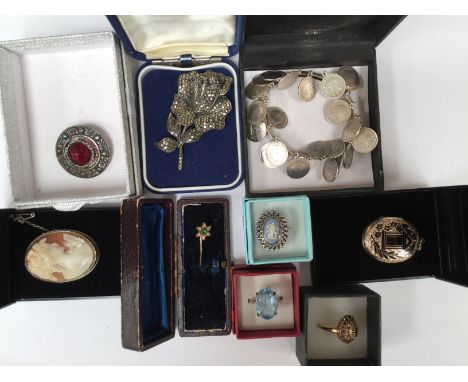 A Victorian Memorial yellow metal locket with black enamel wreath to the front; together with a garnet cluster ring, Continen