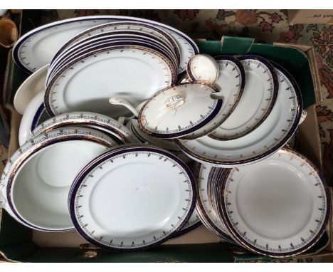 A late Victorian/Edwardian white ground and blue border dinner set, comprising tureen, platter, meat plates, dinner plates, d