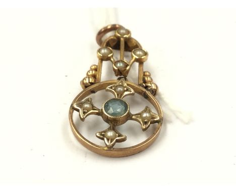 An Art Nouveau yellow metal pendant, having openwork cruciform within ring set around brilliant cut light blue topaz to centr