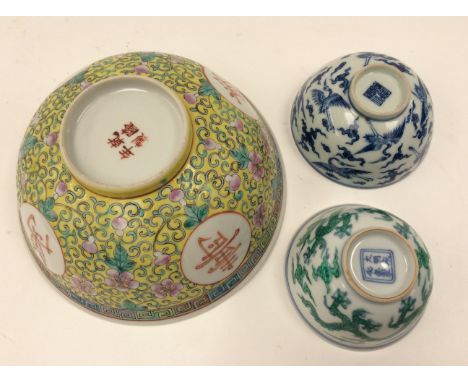 Two Chinese tea bowls, one of step sided footed form, the exterior decorated with five toed dragons and cloud forms painted i
