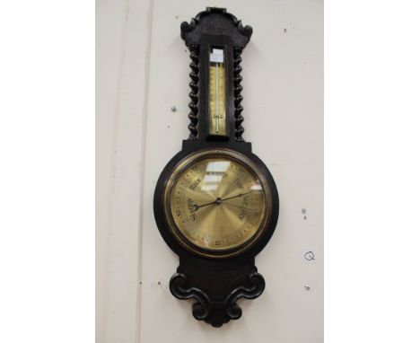 A 1920s oak cased banjo barometer and thermometer, the thermometer section with barley twist columns, 80 cm high approx 