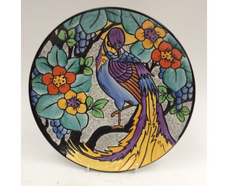 Phoenix ware charger. Tubelined  with  hand painted bird of Paradise amongst floral decoration. Tubelined siganture R. Dean. 