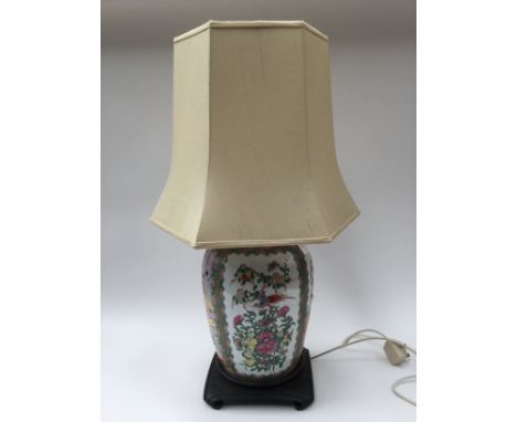 A Chinese ginger jar converted to a table lamp, on wooden stand with shade (1)