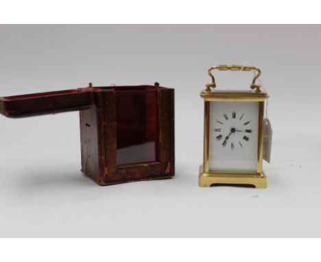 A French brass carriage clock, having white enamel Roman numeral dial with pendulum, diameter  approx 39.5cm x 13cms, in leat