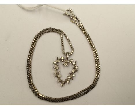 A white metal and diamond heart pedant on chain, 8.5 grams approx 