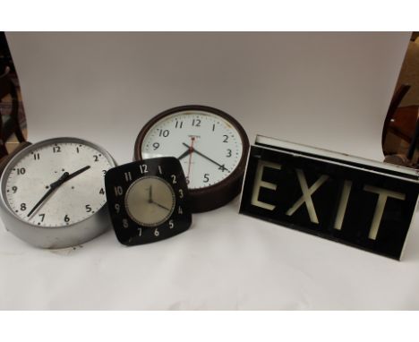 Two Bakelite clocks and two circa 1950s EXIT light signs, possibly from a cinema 