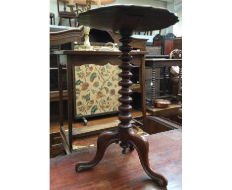 A Victorian mahogany tripod table, the top having a moulded edge, bobbin turned column, raised on three cabriole legs, togeth