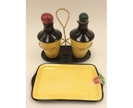  A 1950s Goebel cruet and tray, yellow and black oil and vinegar bottles, in a wire cage (2)
