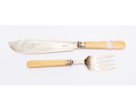  A pair of Victorian silver fish servers, engraved with scrolling foliage, ivory handles with reeded collars, Henry Wilkinson