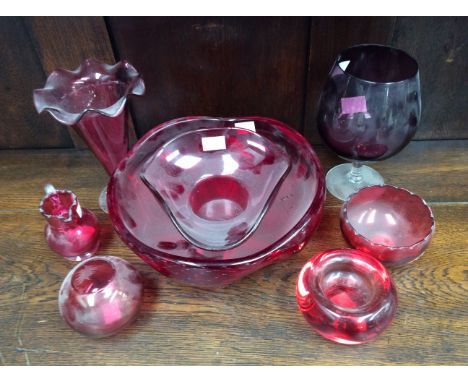 A collection of Cranberry glass, comprising a large size red bubble glass bowl, possibly Whitefriars; together with other Cra